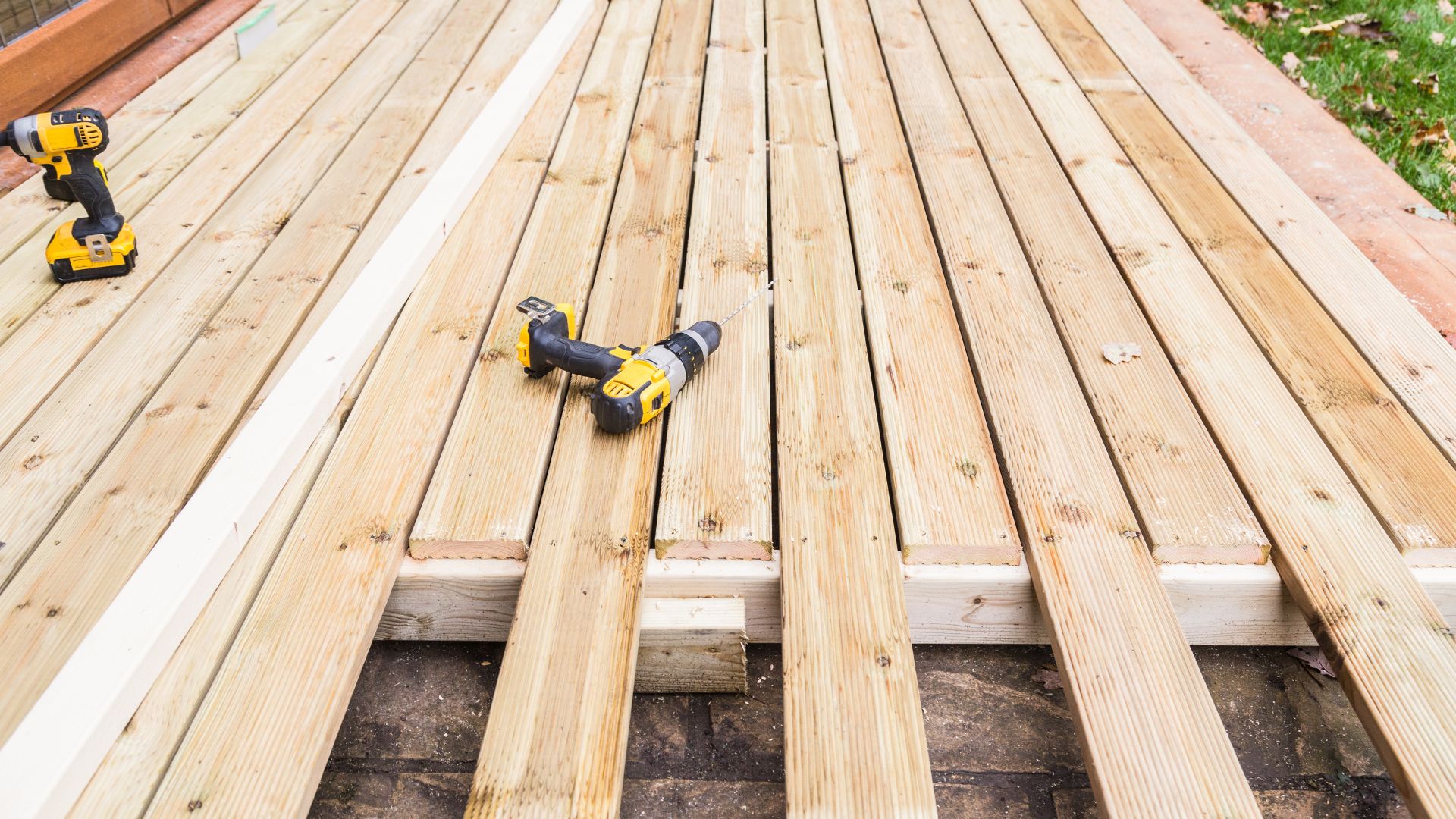 A couple of drillers sitting on top of a wooden deck